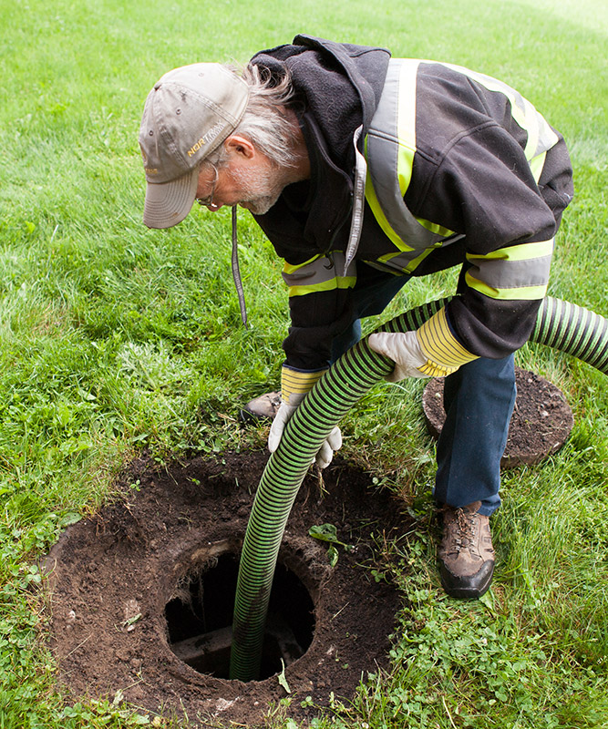 Man pumping out septic