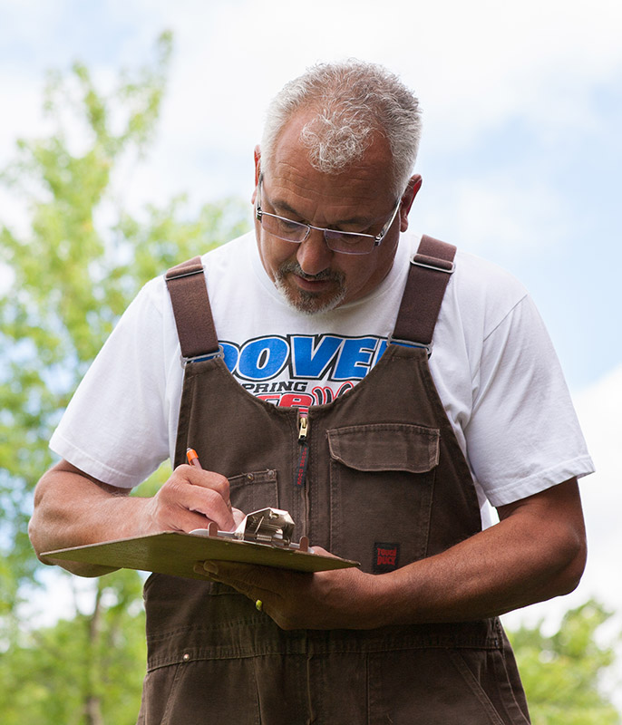 Guy writing on clipboard